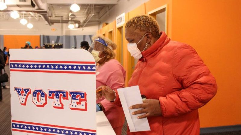 Millions of Americans head to the polls in person