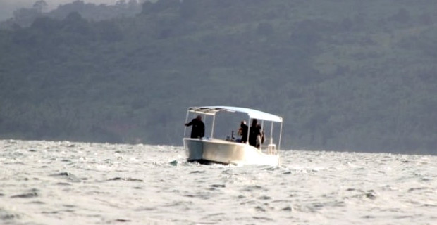 Boats with sonar being used to search for missing helicopter and remaining 2 occupants