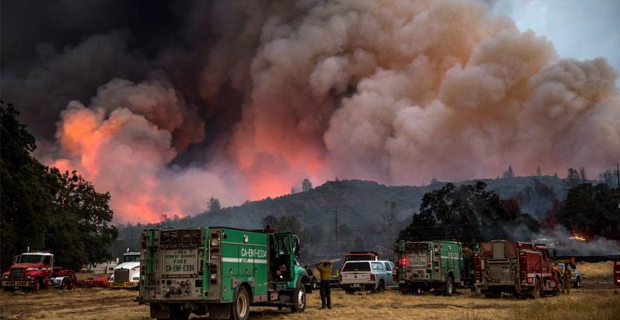 Raging wildfire in northern California kills two firefighters and forces thousands to flee homes