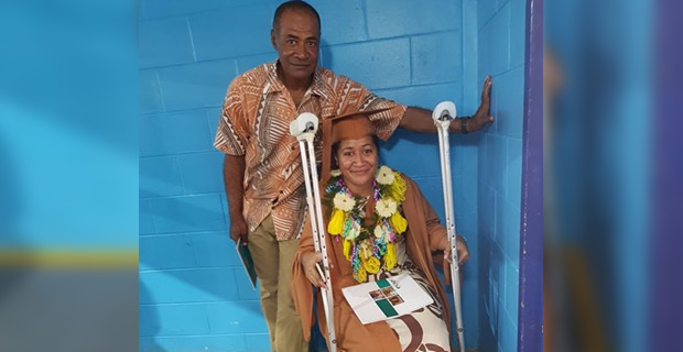 USP graduate Keti Lavenia receives her degree while on crutches