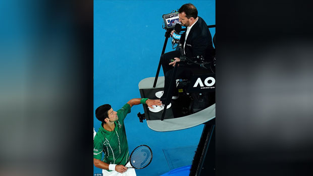 Novak Djokovic apologises for touching umpire's foot during Australian Open