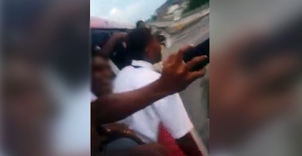 Concerns raised on students seen hanging out the window of a moving bus