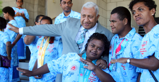 PM dabs with members of Fiji Special Olympics team outside parliament 