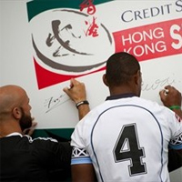 Team captains sign rugby ball for auction 